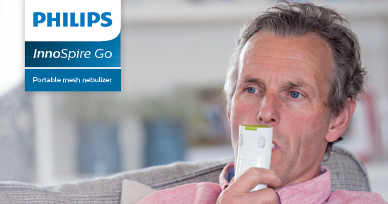 Man uses Nebulizer on couch